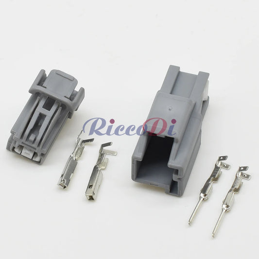 Close-up of terminal pins on 2P automotive connector showing secure electrical contact for automotive wiring
