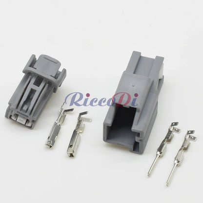 Close-up of terminal pins on 2P automotive connector showing secure electrical contact for automotive wiring