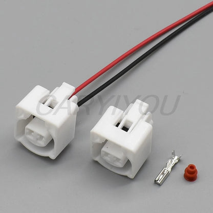 White 2 pin automotive intake air temperature sensor connector installed for secure vehicle wiring connections