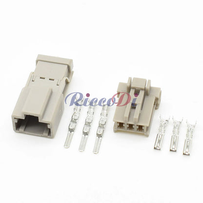 Close-up of 3-pin reversing lamp connector showing male and female terminals for automotive wiring
