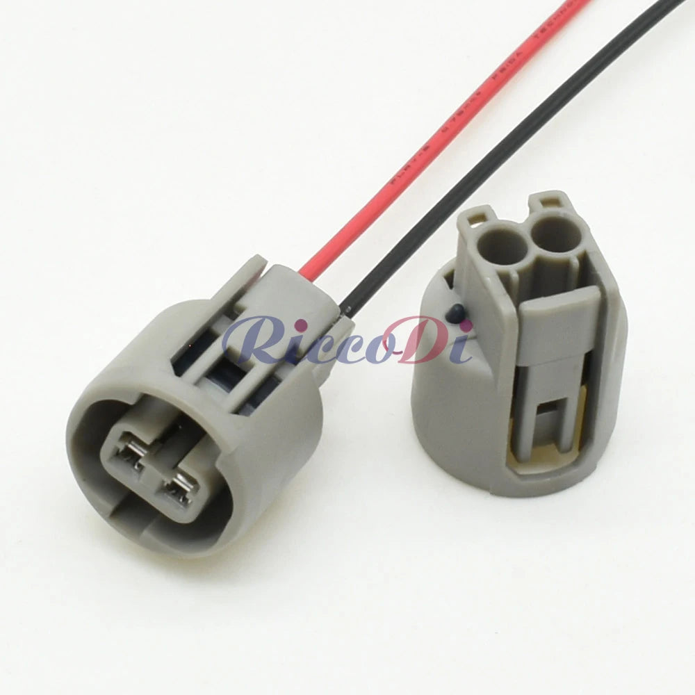 Close-up of 2-pin automotive connector plug highlighting precise pin alignment and secure housing