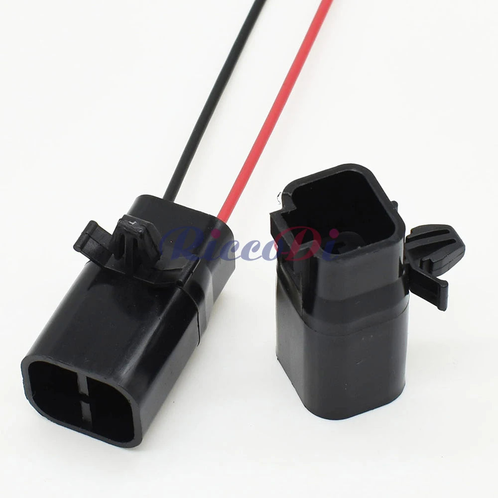 Detail of 15cm wires attached to black 2 pin male automotive connector for secure vehicle connections