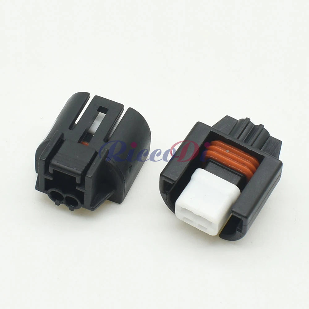 Close-up view of car air conditioner solenoid connector showing detailed pin design and housing