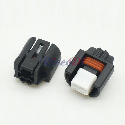 Close-up view of car air conditioner solenoid connector showing detailed pin design and housing