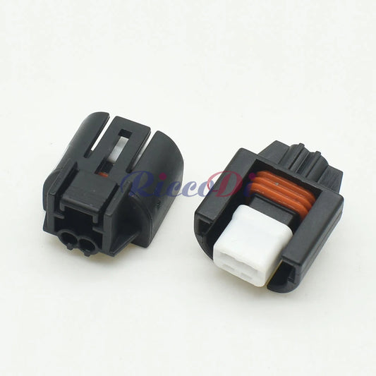 Close-up view of car air conditioner solenoid connector showing detailed pin design and housing