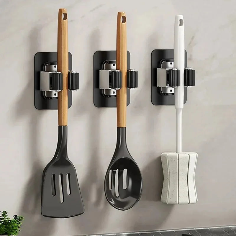 Clip style mop holder for wall mounted storage