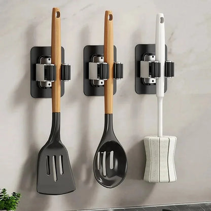 Clip style mop holder for wall mounted storage