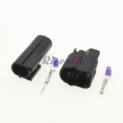 Close-up of male and female connector terminals showing pin and socket interface for reliable automotive electrical connection