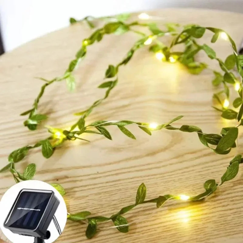 Close-up of artificial green leaf solar LED string lights for Christmas tree and festive holiday decoration