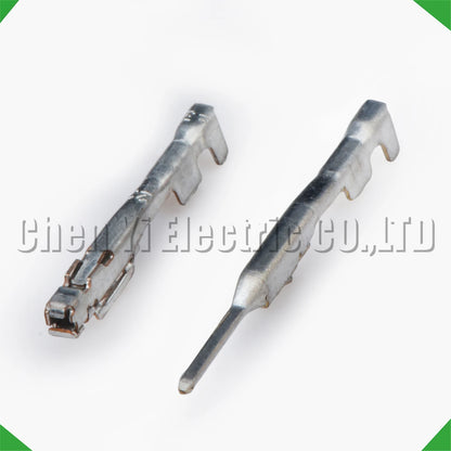 Close-up of 0.6 mm male and female wire crimp pins for automotive connectors