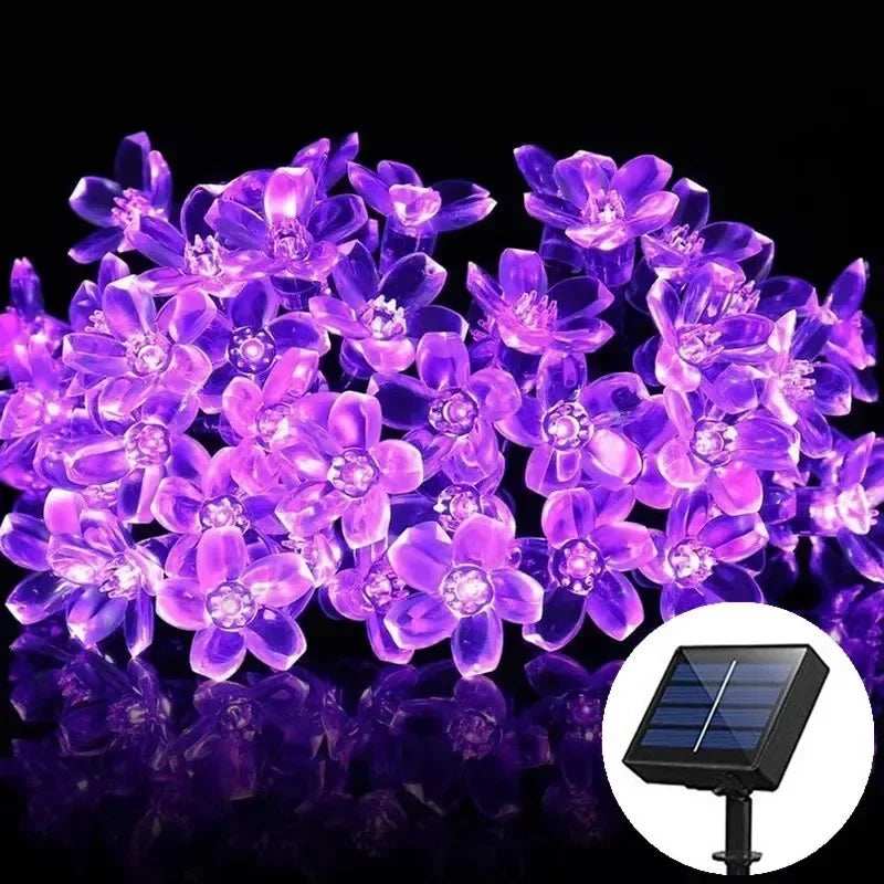 Close-up of solar Sakura LED string lights with peach blossom cherry flowers, perfect for weddings, parties, and outdoor garden decoration