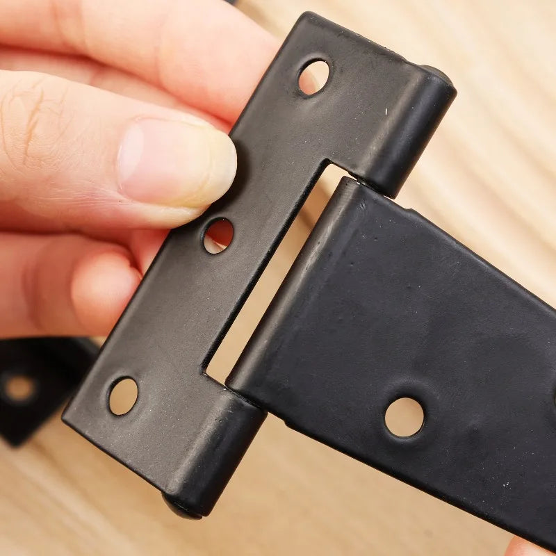 Close-up of iron T shape triangle hinge for doors, gates, and furniture
