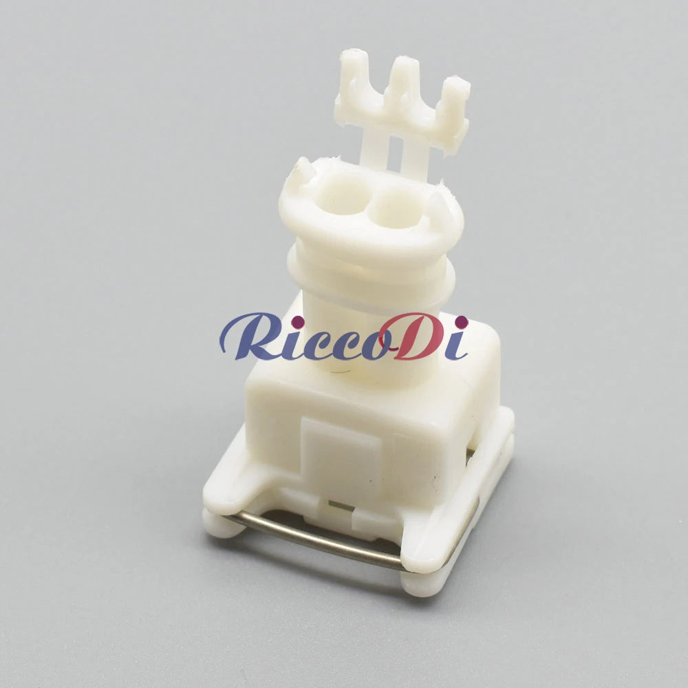 Detailed view of terminals on white female 2-hole automotive wire connector for secure connections